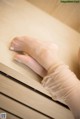 A close up of a woman's feet on a dresser.