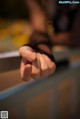 A close up of a person's hand on a table.