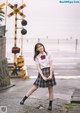 A woman in a school uniform is posing for a picture.