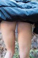 A close up of a woman's butt under a blanket.