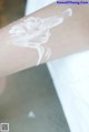 A close up of a person's arm with a lot of cream on it.