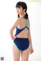 A woman in a blue and blue one piece swimsuit.